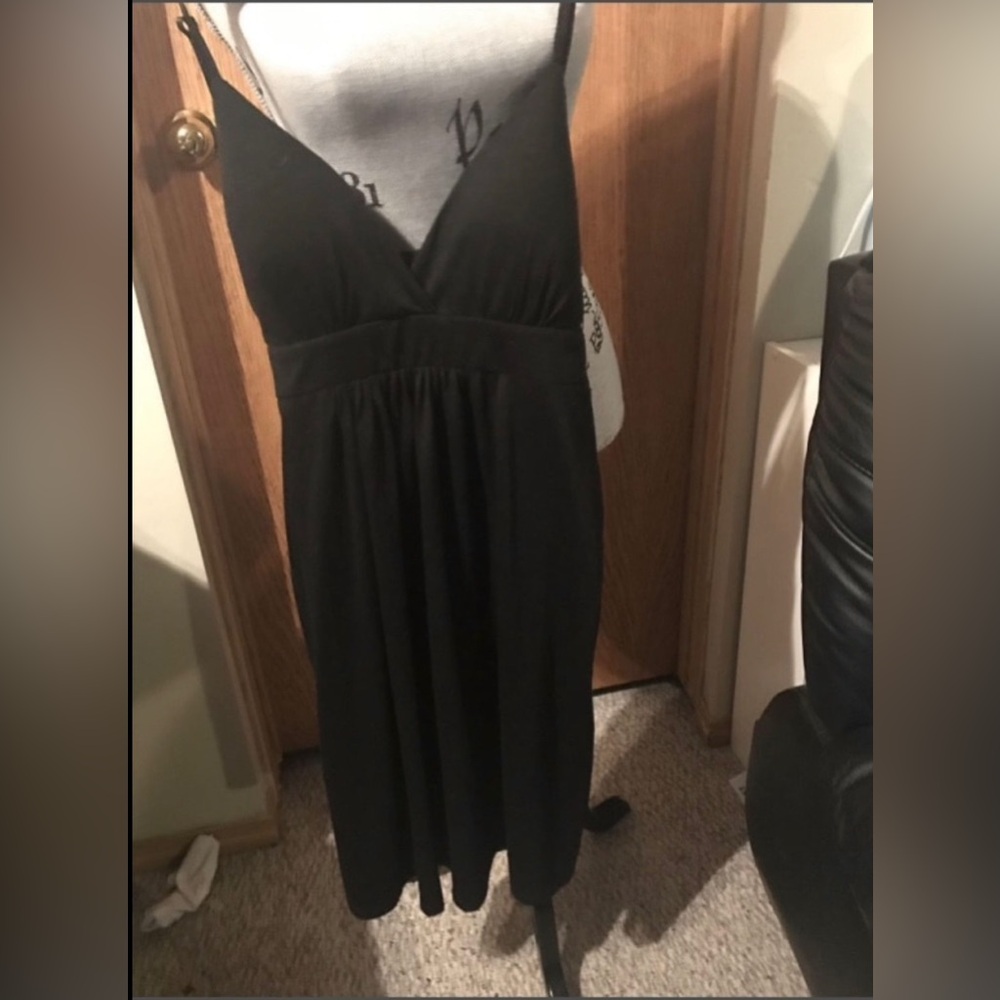 Black v-neck spaghetti strap dress. With padding in chest